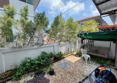 Cozy residential garden with pebble path and outdoor seating area