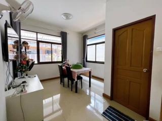 Bright and cozy living space with dining area and glossy tiled flooring