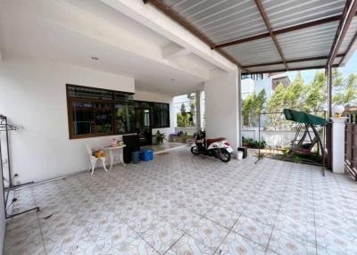 Spacious covered patio area with patterned tile flooring and natural light