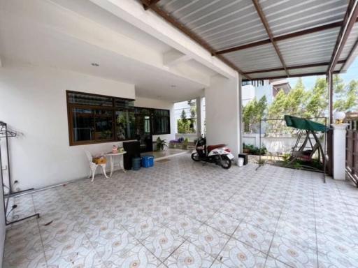 Spacious covered patio area with patterned tile flooring and natural light