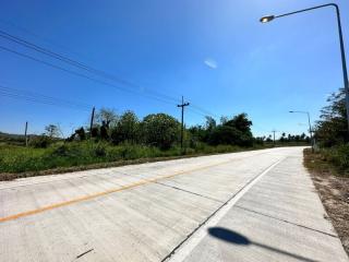 Paved road with streetlight and clear blue sky