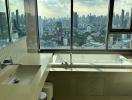 Modern bathroom with large windows overlooking the city skyline