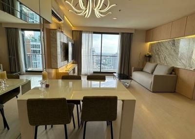 Modern living room with dining area and city view