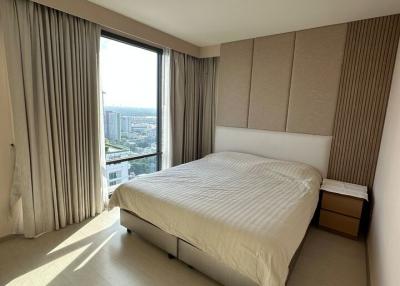 Modern bedroom with large windows and city view