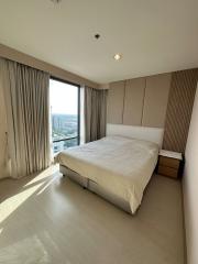 Modern bedroom with large windows and city view