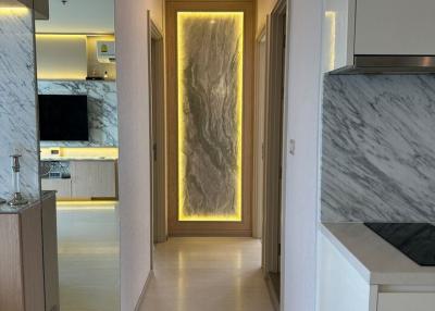 Modern apartment interior hallway with marble accents and integrated lighting