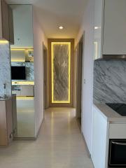 Modern apartment interior hallway with marble accents and integrated lighting