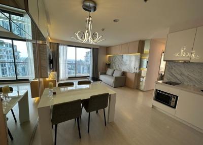 Modern living room with dining area and open kitchen in an apartment