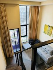 Modern apartment living room with balcony access and large windows