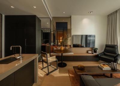 Modern living room with open kitchen design, featuring elegant furniture and sophisticated interior decoration