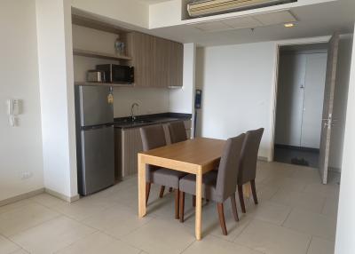 Modern kitchen with wooden cabinets and dining area with a wooden table and chairs