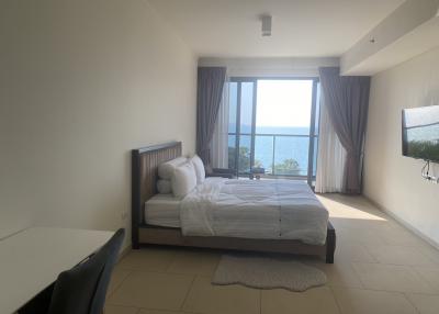 Bright bedroom with large windows overlooking the sea
