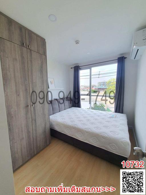 Cozy bedroom with large bed and wooden wardrobe