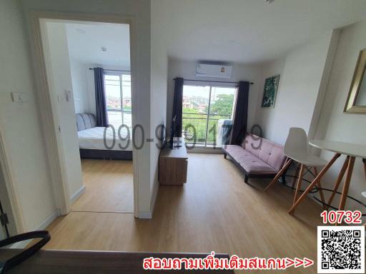 Open concept apartment interior with a view of the bedroom and balcony