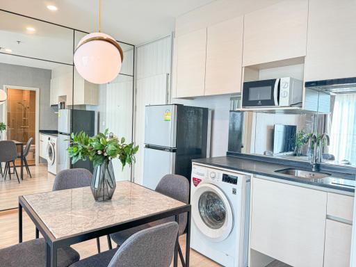 Modern kitchen with integrated appliances and dining area