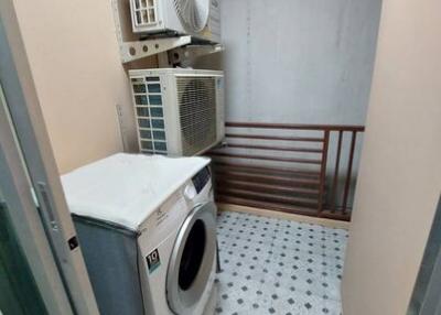 Compact laundry room with washing machine and air conditioning unit