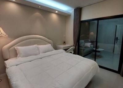 Modern bedroom with ambient lighting and glass door