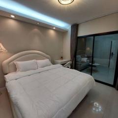 Modern bedroom with ambient lighting and glass door