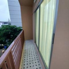 Spacious balcony with patterned floor tiles and glass sliding doors