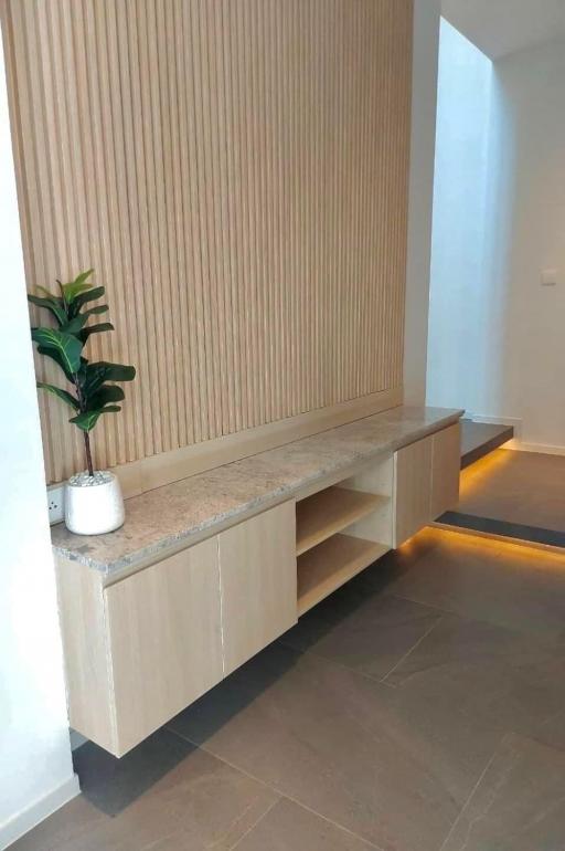 Modern hallway interior with wooden wall paneling and built-in bench