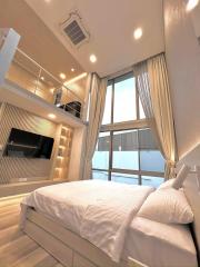 Modern bedroom with large bed, bright interior, and built-in shelves