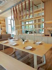 Stylish dining room with modern wooden table and designer pendant lights