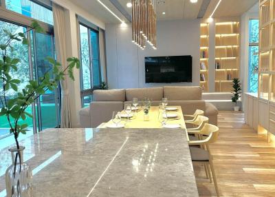 Modern living room with open dining area and kitchen counter