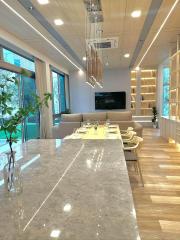 Modern living room with open dining area and kitchen counter