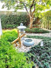 Tranquil garden with decorative fountain and lush greenery