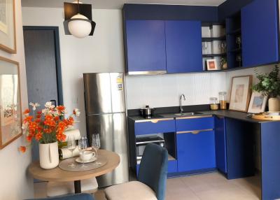 Modern kitchen with blue cabinetry and stainless steel appliances