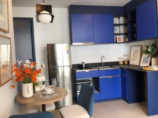 Modern kitchen with blue cabinetry and stainless steel appliances