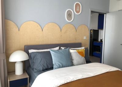 Modern bedroom with stylish headboard and decorative wall hangings