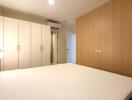 Spacious bedroom with large bed and fitted wardrobes