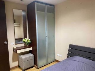 Cozy bedroom with a large wardrobe and comfortable bedding