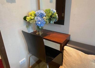 Cozy corner with wooden desk and chair featuring colorful flowers