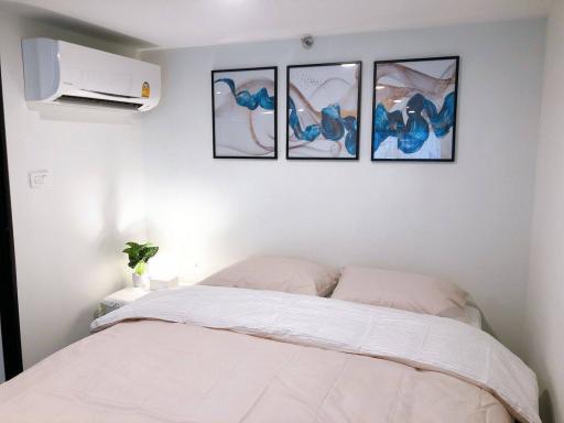 Cozy modern bedroom with well-made bed and wall art