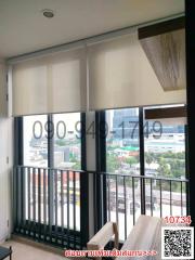 Modern balcony with a city view, transparent railings, and outdoor seating