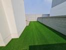 Spacious backyard with artificial turf and privacy fencing
