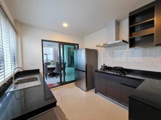 Modern kitchen with stainless steel appliances and access to dining area
