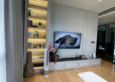 Modern living room with wall-mounted TV and built-in shelves