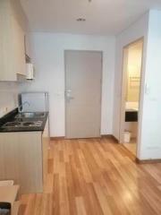 Compact kitchen with modern appliances and wooden flooring