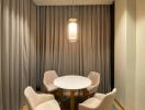 Modern dining area with a round table and comfortable chairs