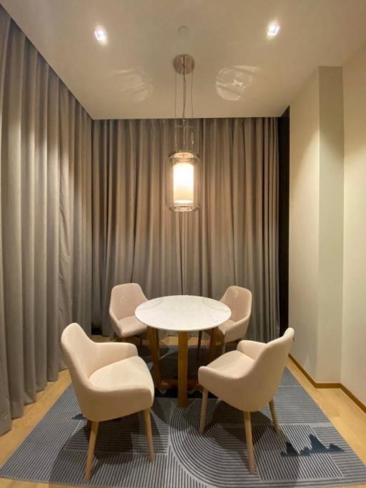 Modern dining area with a round table and comfortable chairs