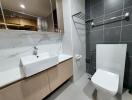 Modern bathroom with grey tiles and walk-in shower