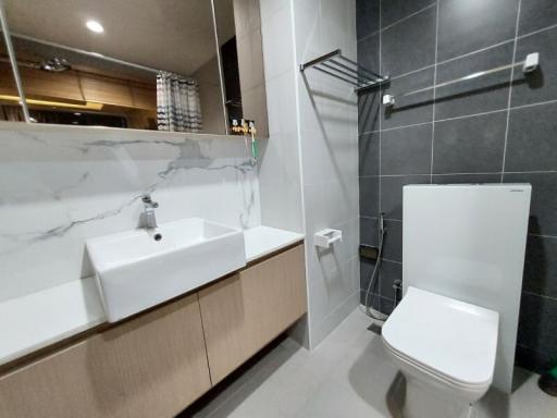 Modern bathroom with grey tiles and walk-in shower