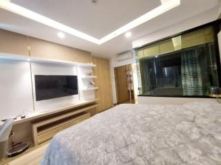 Modern bedroom with large bed and ambient lighting