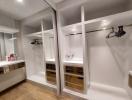 Modern walk-in closet with ample shelving and storage space