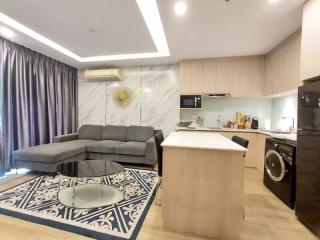 Modern open-concept living room with adjacent kitchen area