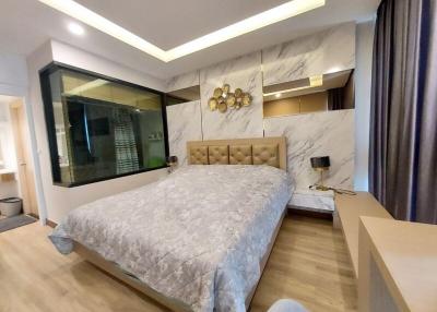 Modern bedroom with marble wall accents and built-in wardrobe