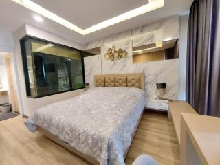 Modern bedroom with marble wall accents and built-in wardrobe